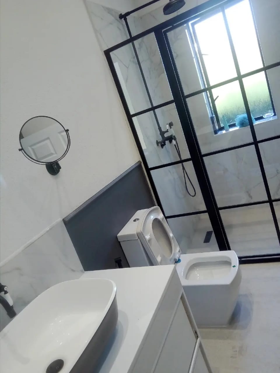 Full bathroom renovation completed by Onedays Plumbing Services in Cape Town — new vanity, shower, tiling, and plumbing connections